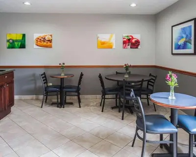a waiting room with two tables and chairs at Quality Inn Dundee in Dundee