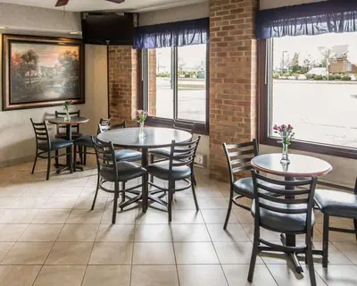 a restaurant with tables and chairs and a window at Quality Inn Dundee in Dundee