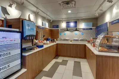 a fast food restaurant with wooden counters and a bakery at Holiday Inn Express - Cincinnati North - Monroe by IHG in Monroe