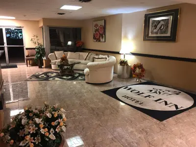 a living room with a couch and flowers on the floor at Wolf Inn Hotel in Sandusky