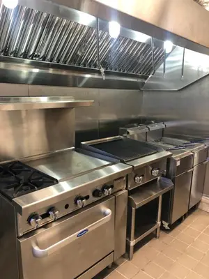 a kitchen with stainless steel appliances in a kitchen at Wolf Inn Hotel in Sandusky