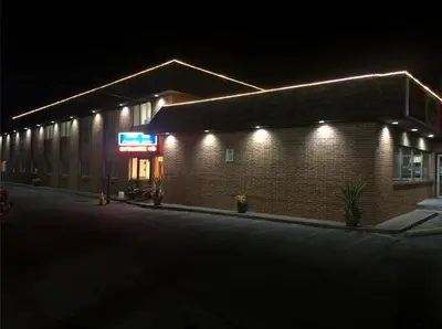 a brick building with lights on the side of it at Wolf Inn Hotel in Sandusky