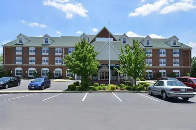 a large building with cars parked in a parking lot at BlissPoint Inn & Suites Marion in Marion
