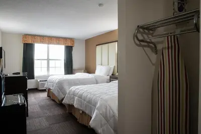 a hotel room with two beds and a window at BlissPoint Inn & Suites Marion in Marion