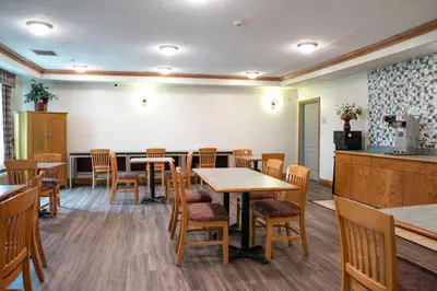 a dining room with wooden tables and chairs at BlissPoint Inn & Suites Marion in Marion