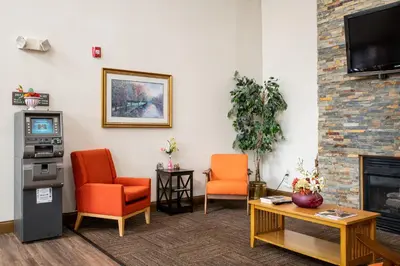 a living room with two chairs and a fireplace at BlissPoint Inn & Suites Marion in Marion
