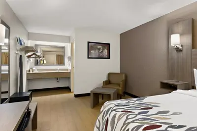 a hotel room with a bed and a bathroom at Red Roof Inn Cleveland - Westlake in Westlake