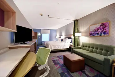 a hotel room with a bed and a couch at Home2 Suites By Hilton Georgetown in Georgetown