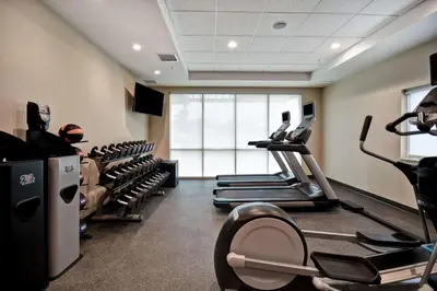 a gym with treadmills and ellipticals in a room at Home2 Suites By Hilton Georgetown in Georgetown