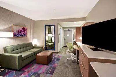 a living room with a couch and a flat screen tv at Home2 Suites By Hilton Georgetown in Georgetown