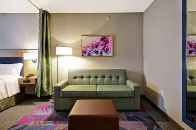 a hotel room with a couch and a bed at Home2 Suites By Hilton Georgetown in Georgetown