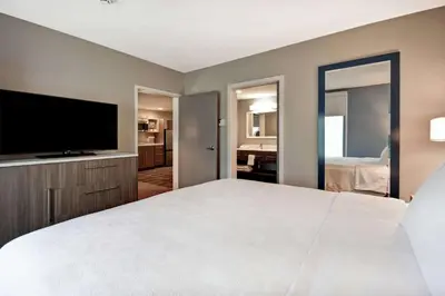 a bedroom with a large bed and a flat screen tv at Home2 Suites By Hilton Georgetown in Georgetown
