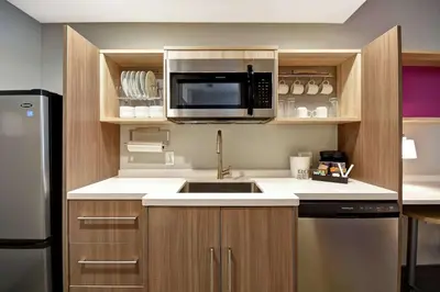 a kitchen with a sink and a microwave at Home2 Suites By Hilton Georgetown in Georgetown