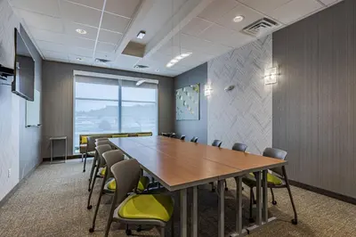 a conference room with a wooden table and chairs at SpringHill Suites by Marriott Fort Wayne North in Sunnybrook Acres