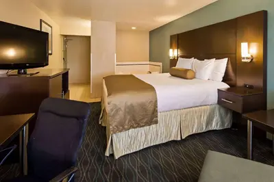 a hotel room with a bed and a flat screen tv at Baymont by Wyndham Marion, OH in Marion