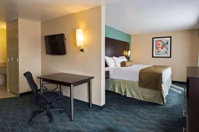 a hotel room with a bed and a desk at Baymont by Wyndham Marion, OH in Marion