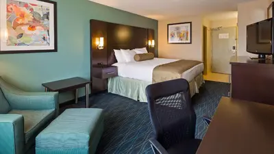 a hotel room with a bed and a television at Baymont by Wyndham Marion, OH in Marion