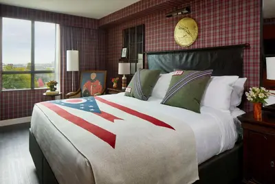 a bedroom with a large bed with an american flag blanket at Graduate by Hilton Columbus in Columbus