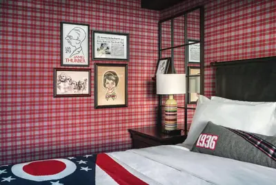 a bedroom with a bed and pictures on the wall at Graduate by Hilton Columbus in Columbus