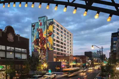 a city street with a building with a mural on it at Graduate by Hilton Columbus in Columbus