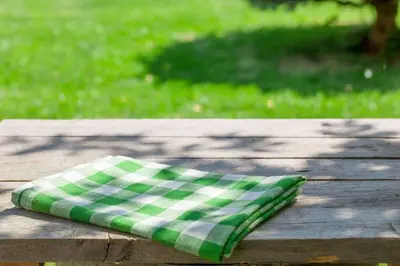 a green and white pillow sitting on a wooden table at Extended Stay America Suites - Fort Wayne - South in Fort Wayne