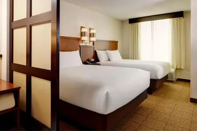 a hotel room with two beds and a window at Hyatt Place Fort Wayne - Northwest in Fort Wayne