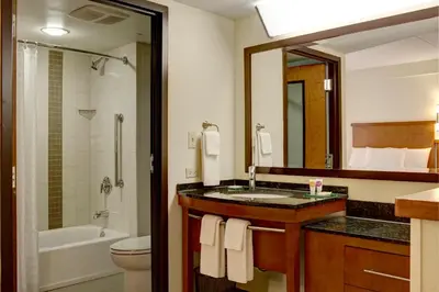 a bathroom with a sink and a toilet and a mirror at Hyatt Place Fort Wayne - Northwest in Fort Wayne