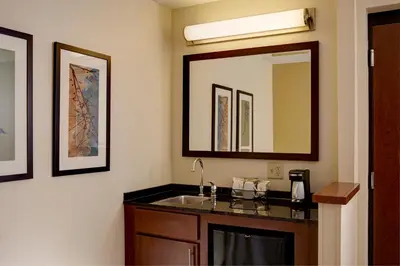 a bathroom with a sink and a mirror at Hyatt Place Fort Wayne - Northwest in Fort Wayne