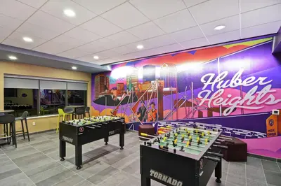 a room with two chess tables and a mural at Tru By Hilton Huber Heights Dayton in Huber Heights