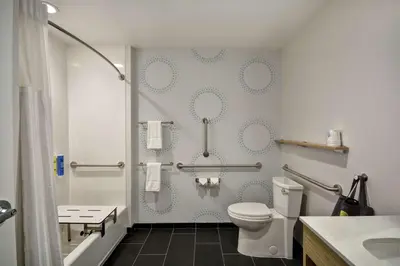 a bathroom with a white toilet and a shower at Tru By Hilton Huber Heights Dayton in Huber Heights