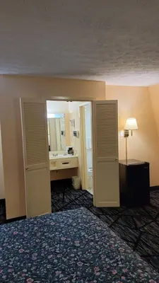 a hotel room with a bed and a bathroom at Guest Keeper Inn in Van Wert