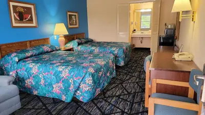 a hotel room with two beds and a couch at Guest Keeper Inn in Van Wert