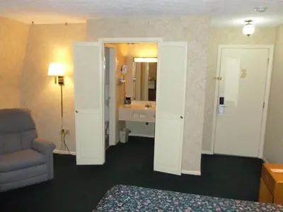 a hotel room with a bed and a bathroom at Guest Keeper Inn in Van Wert