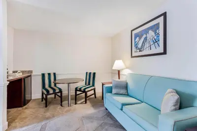 a living room with a couch and a table at The Blu Hotel Blue Ash Cincinnati, an Ascend Collection Hotel in Blue Ash