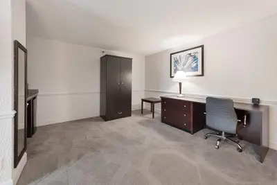 an office with a desk and a chair in a room at The Blu Hotel Blue Ash Cincinnati, an Ascend Collection Hotel in Blue Ash