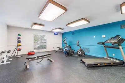 a gym with several exercise equipment in a room at The Blu Hotel Blue Ash Cincinnati, an Ascend Collection Hotel in Blue Ash