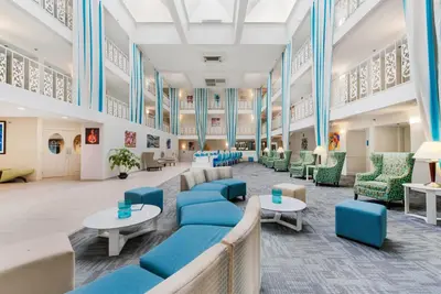 a large lobby with blue chairs and tables at The Blu Hotel Blue Ash Cincinnati, an Ascend Collection Hotel in Blue Ash