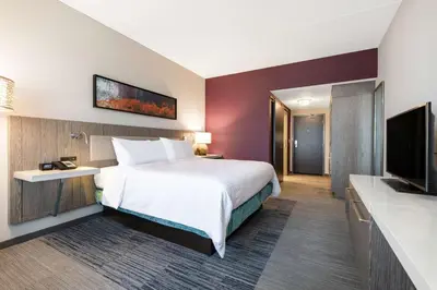 a hotel room with a bed and a flat screen tv at Hilton Garden Inn Pittsburgh Area Beaver Valley, Pa in Monaca
