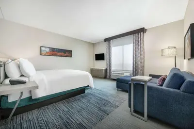 a hotel room with a bed and a couch at Hilton Garden Inn Pittsburgh Area Beaver Valley, Pa in Monaca