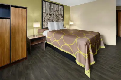 a hotel room with a large bed and a desk at Super 8 by Wyndham St. Clairsville OH/Wheeling WV Area in Saint Clairsville