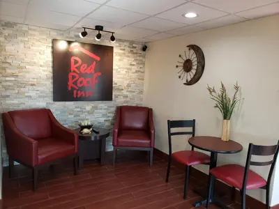 a waiting room with chairs and a red roof inn sign at Red Roof Inn Wheelersburg in Wheelersburg