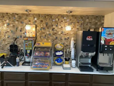 a counter with a refrigerator and other items on it at Red Roof Inn Wheelersburg in Wheelersburg