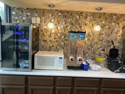 a kitchen counter with a microwave and other kitchen items at Red Roof Inn Wheelersburg in Wheelersburg