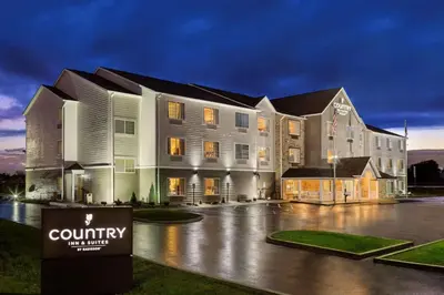 a large building with a sign in front of it at Country Inn & Suites by Radisson, Marion, OH in Marion