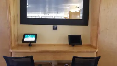 a desk with a computer and a tv on it at Baymont by Wyndham Lawrenceburg in Lawrenceburg