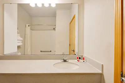 a bathroom with a sink and a mirror at Baymont by Wyndham Lawrenceburg in Lawrenceburg