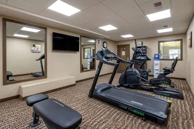a gym with two exercise bikes in a room at Comfort Inn & Suites Northern Kentucky in Wilder