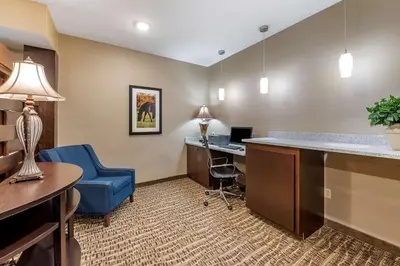 an office with a desk and a blue chair in a room at Comfort Inn & Suites Northern Kentucky in Wilder