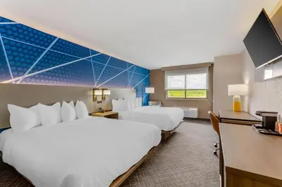 a hotel room with two beds and a flat screen tv at Comfort Inn River's Edge in Huron