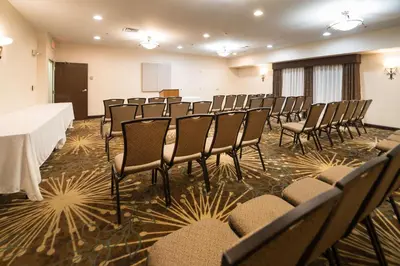a room with a bunch of chairs and a table at Hampton Inn Tiffin in Tiffin